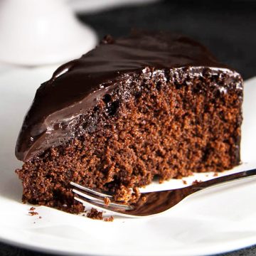 close up of chocolate honey cake on white plate