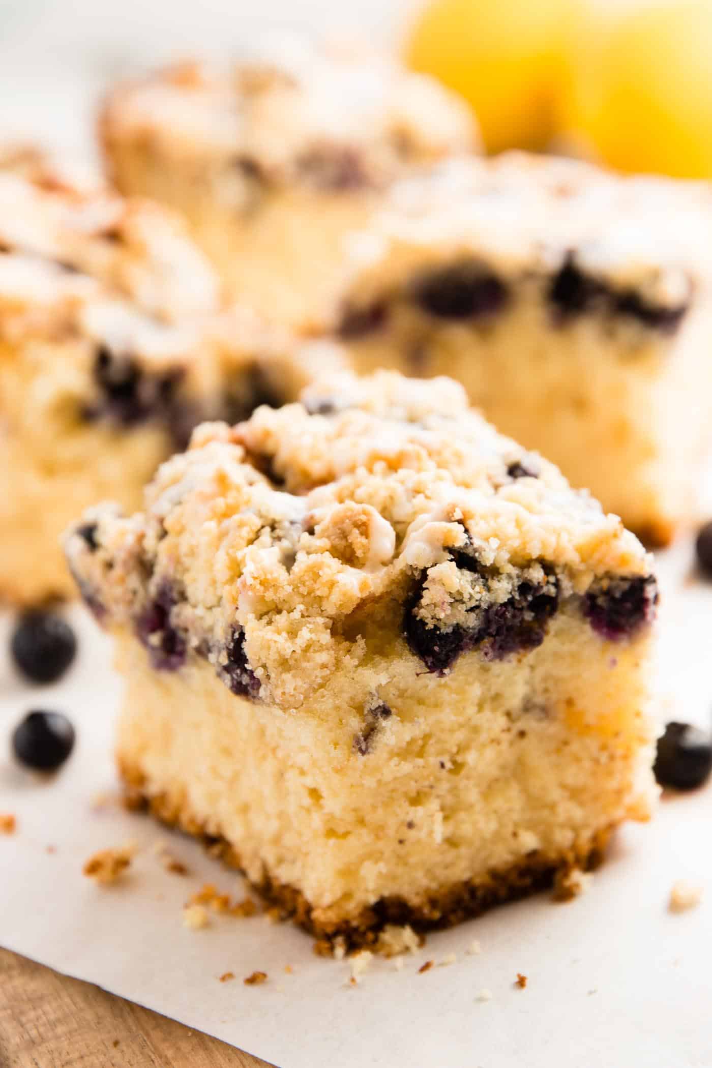 squares of lemon blueberry coffee cake on parchment paper