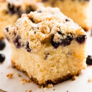 slice of lemon blueberry coffee cake on parchment paper