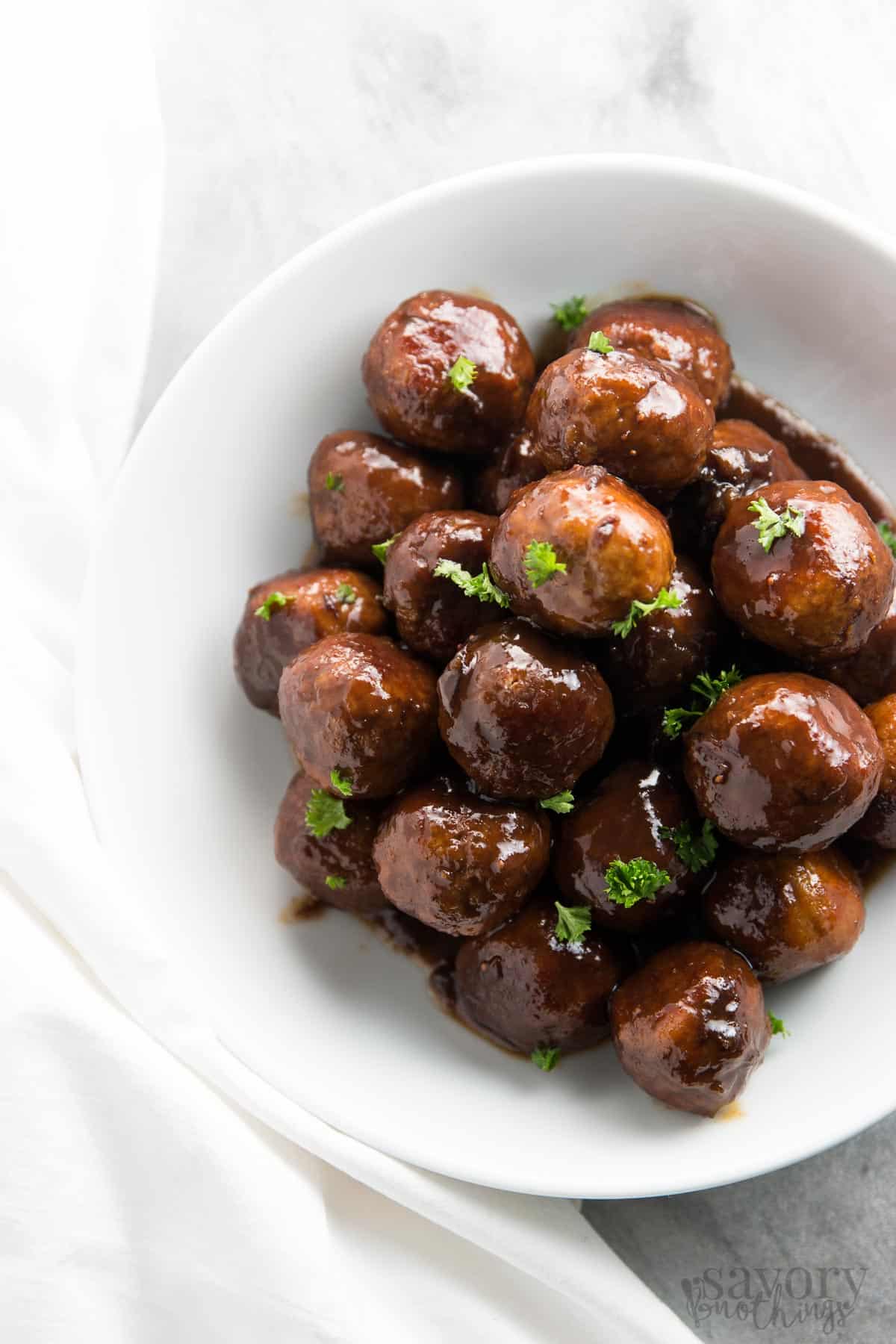 top down view on cranberry turkey meatballs in white bowl