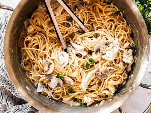 skillet with turkey tetrazzini surrounded by parmesan and parsley