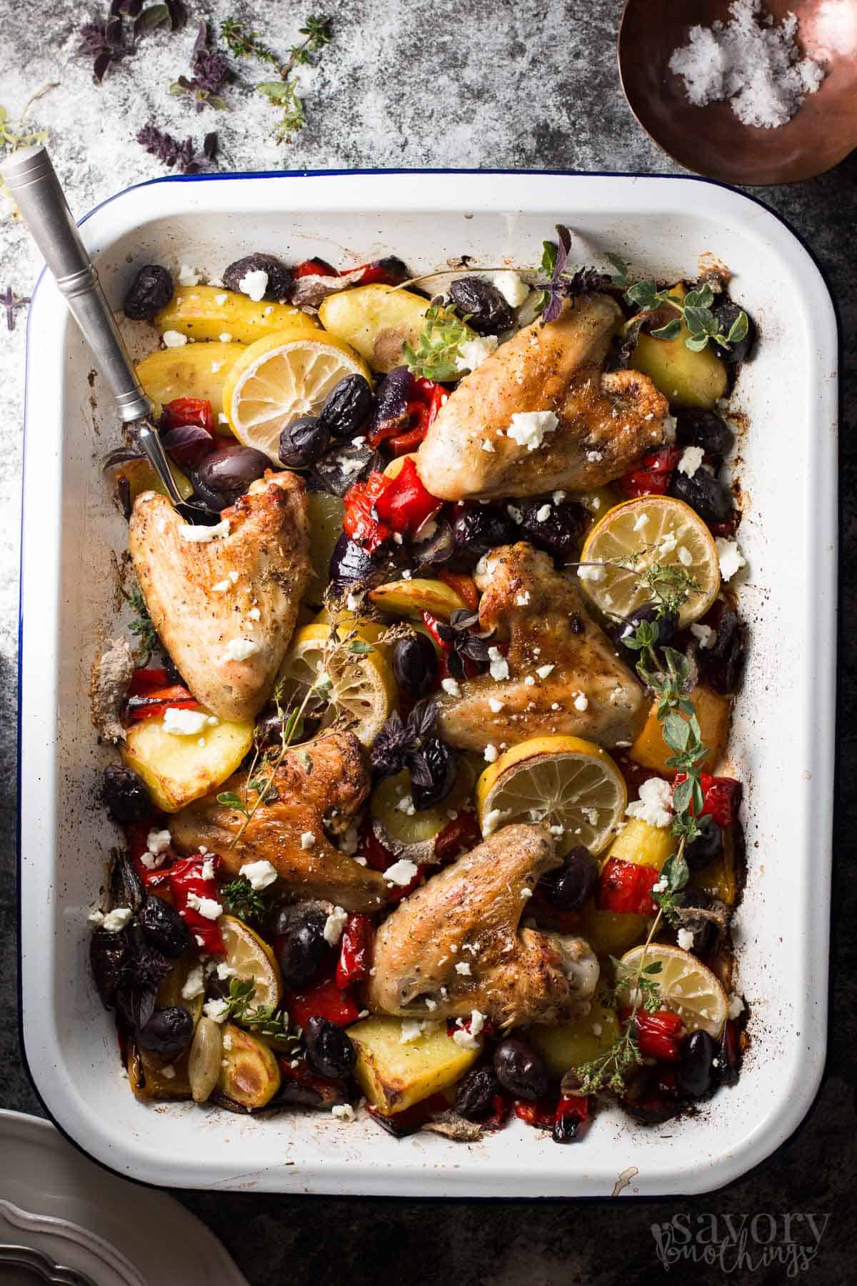 top down view on white enamel pan filled with greek chicken