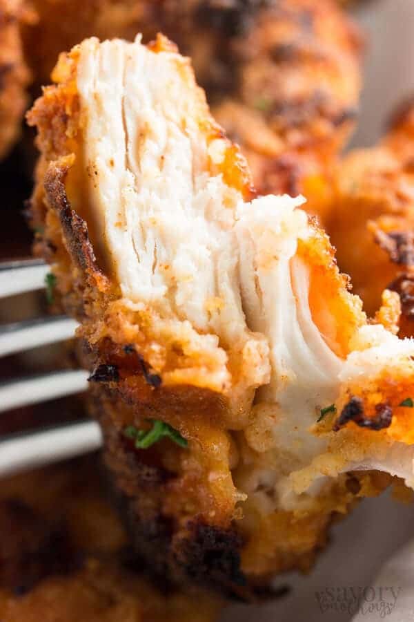 close up photo of a cut open piece of oven fried chicken