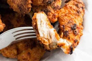 Crispy oven fried chicken on a fork.