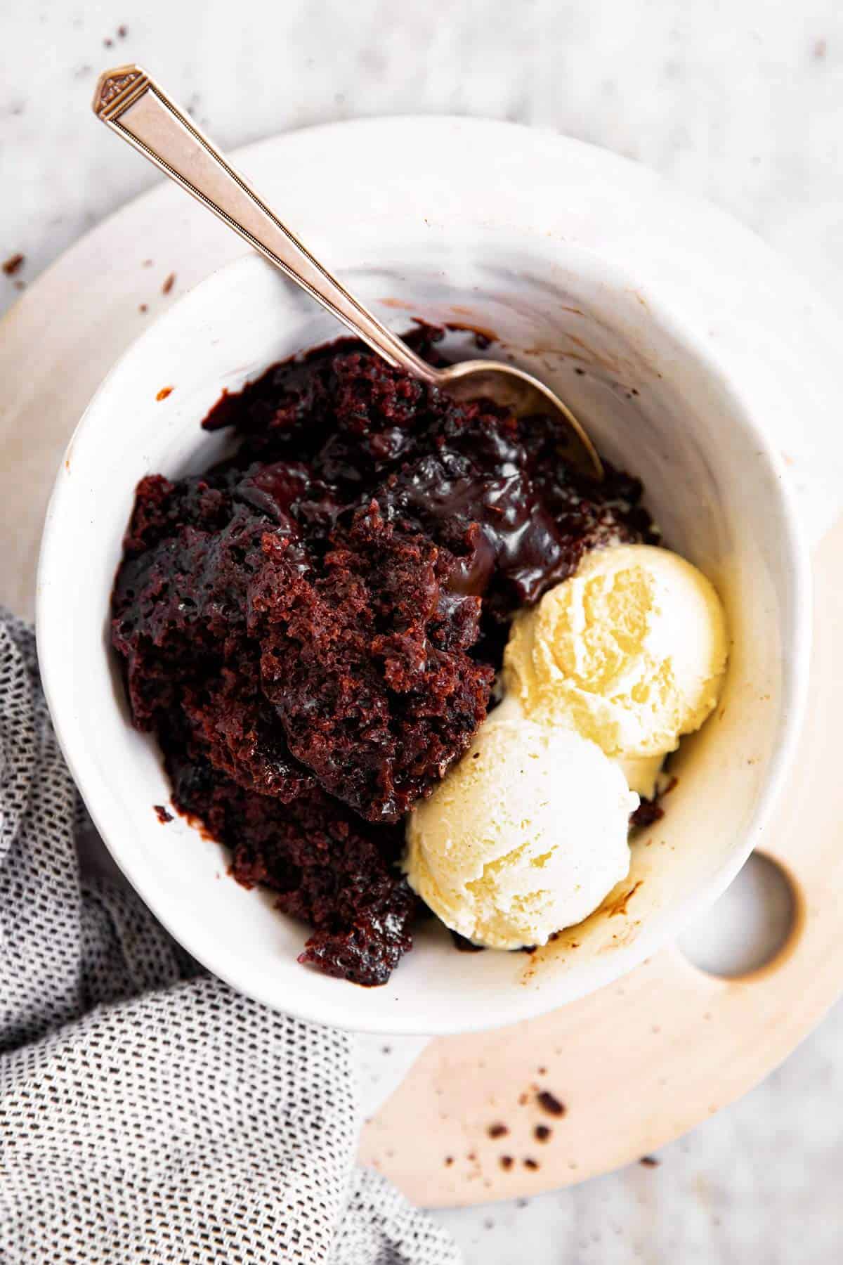 white bowl with chocolate pudding cake and ice cream