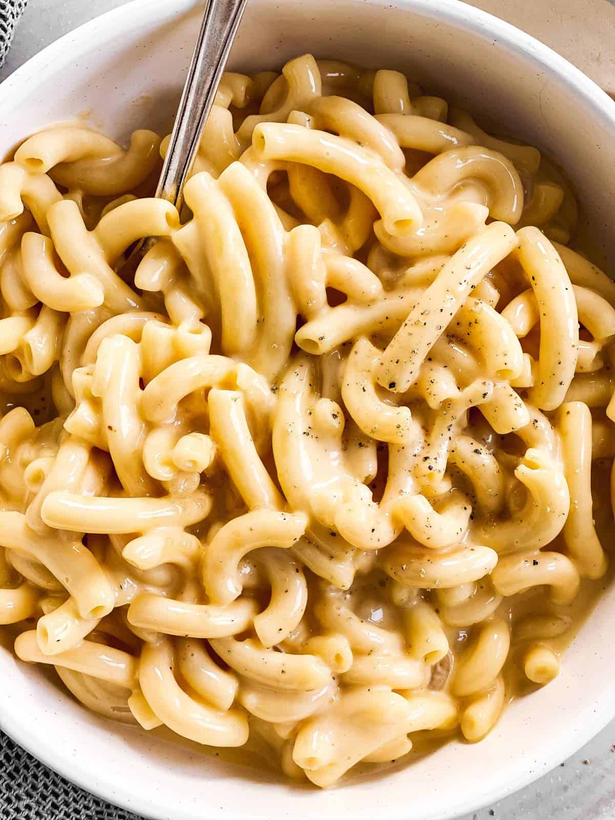 close up photo of Mac and cheese in a white bowl