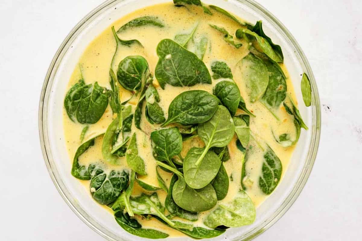 Making the filling for tomato spinach feta quiche.