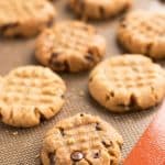several chocolate chip peanut butter cookies on silicone baking mat