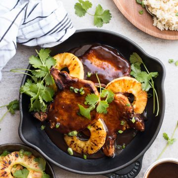 top down view on pineapple bbq pork chops in black skillet