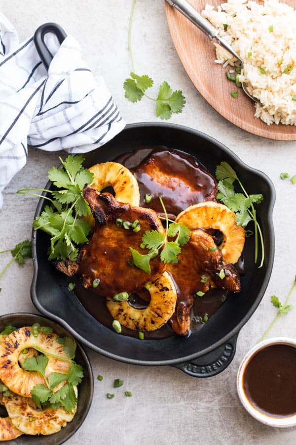 top down view on pineapple bbq pork chops in black skillet