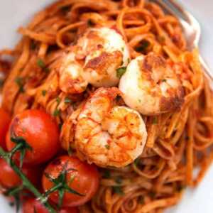 overhead closeup of shrimp on tomato pasta