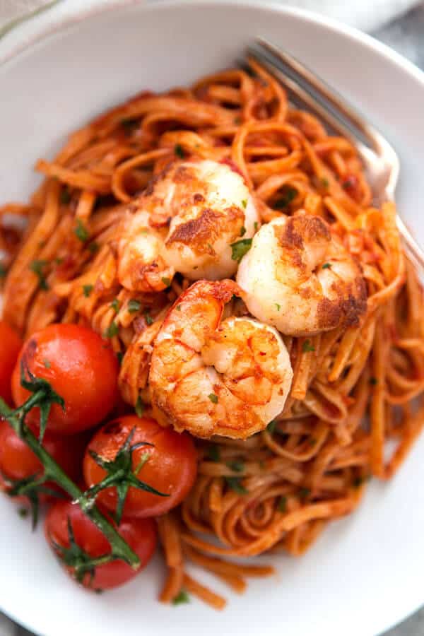 overhead closeup of shrimp on tomato pasta