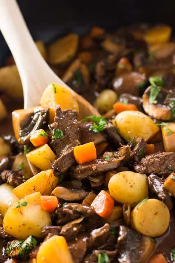 Close up of potato, beef tips and gravy skillet.
