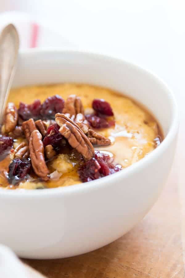 close up photo of pecans and cranberries on top of pumpkin oatmeal