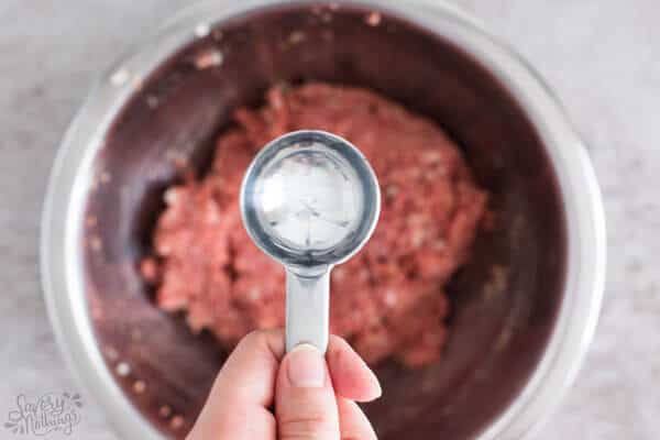 close up of tablespoon over bowl of ground beef
