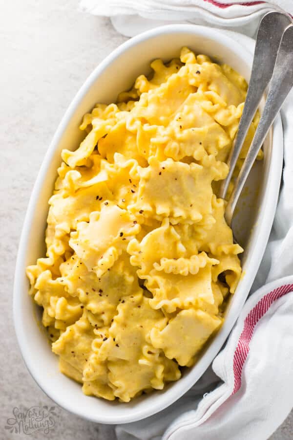 top down view on white dish with creamy butternut squash pasta