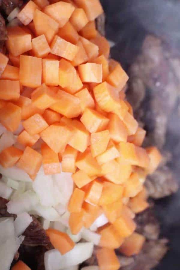 diced onions and carrots in a close up photo