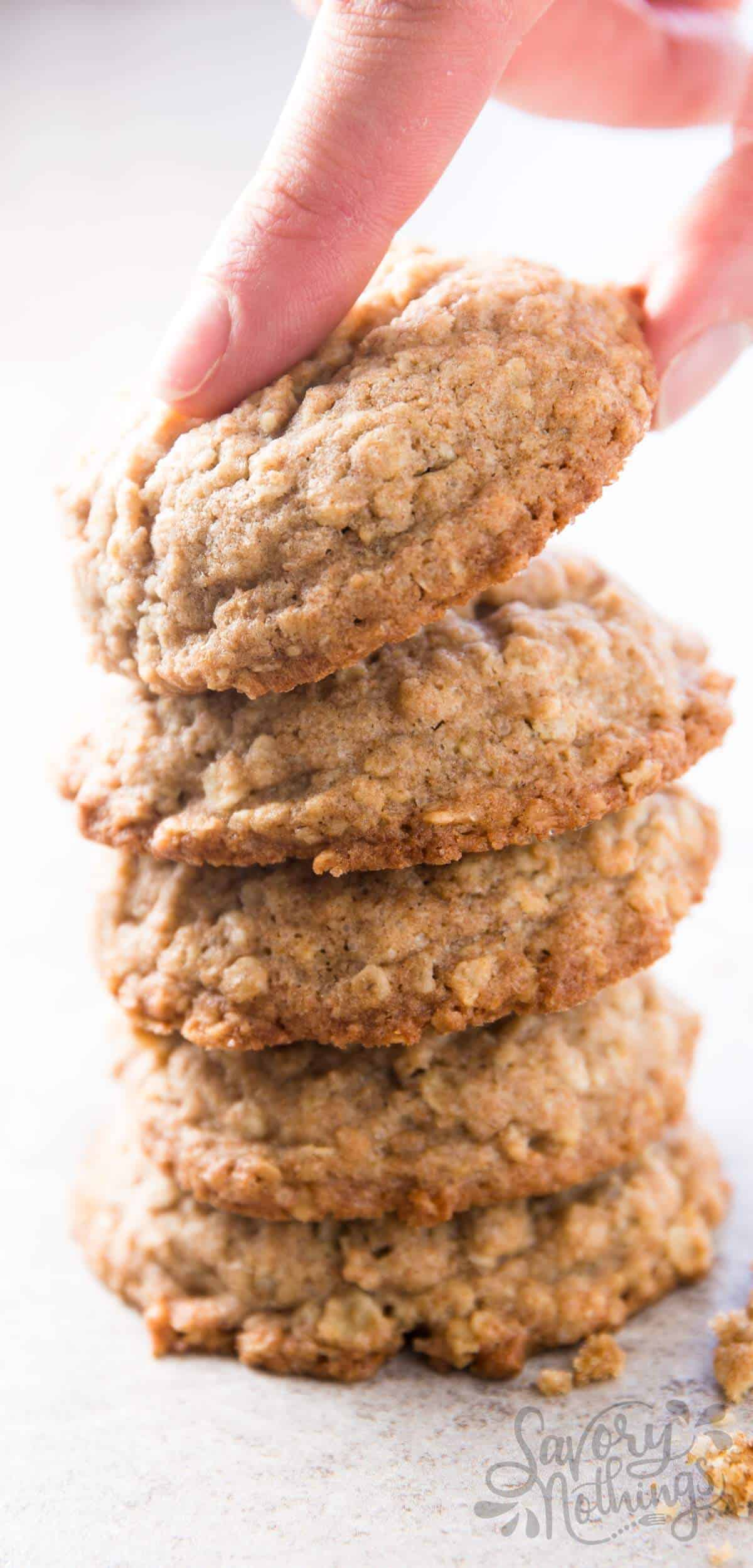 female hand taking an oatmeal cookie   from a stack