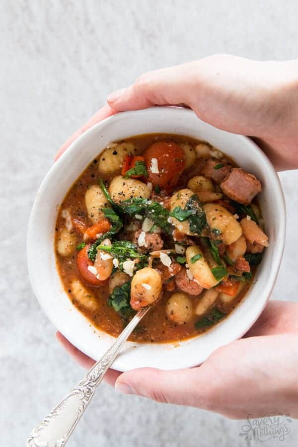 female hands holding bowl with tuscan gnocchi