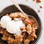 easy apple crisp in a bowl with a spoon and ice cream
