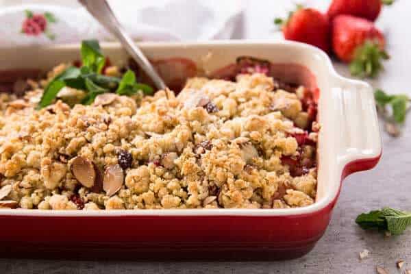 red casserole dish with strawberry rhubarb crisp