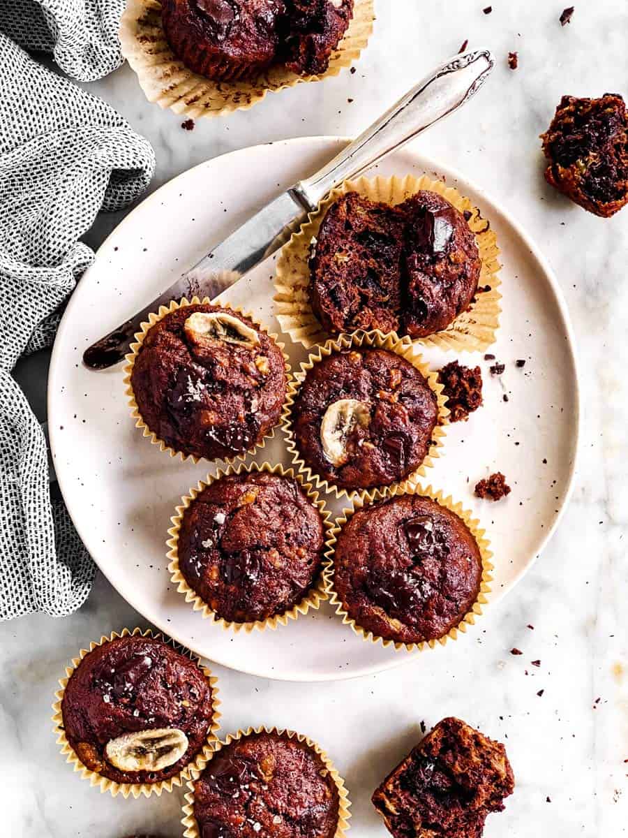 overhead view of chocolate banana muffins on white plate