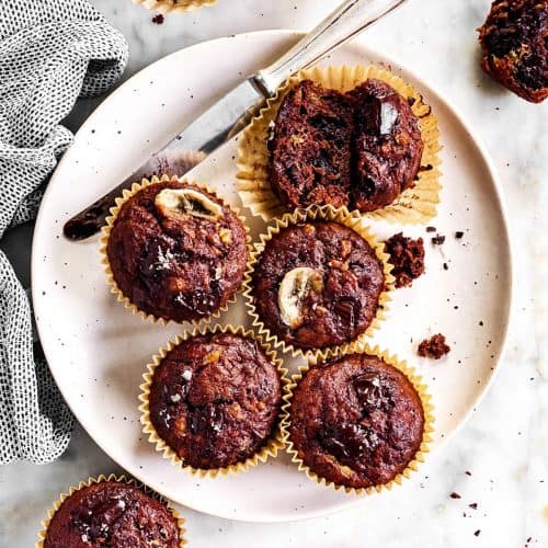 overhead view of chocolate banana muffins on white plate