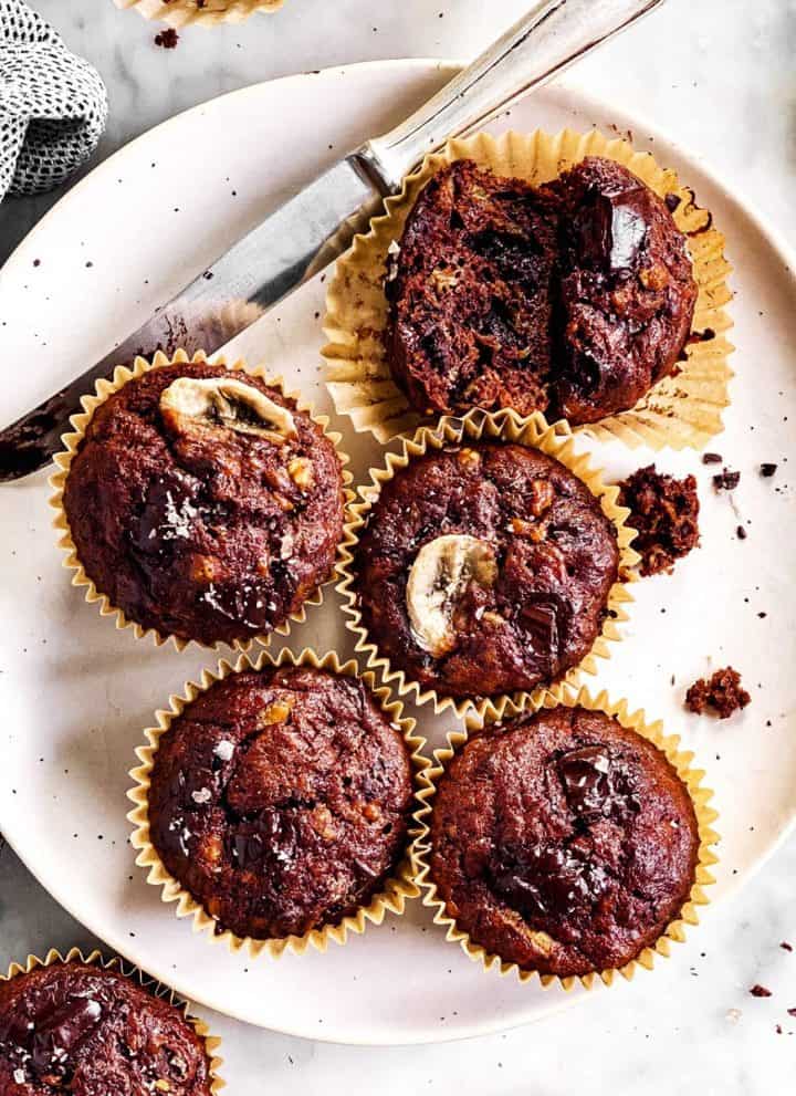overhead view of chocolate banana muffins on white plate