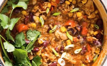 overhead view on red Dutch oven filled with burrito chicken and rice