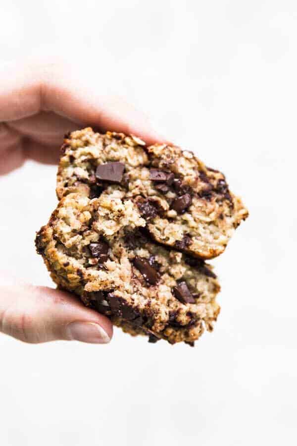 female hand holding a sliced open baked oatmeal cup