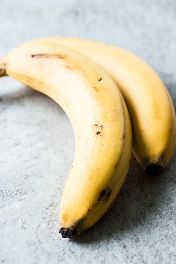 two bananas on light surface