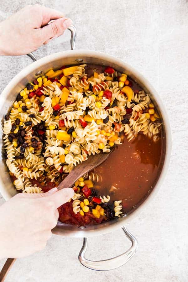 One Pot Black Bean Enchilada Pasta is a simple vegetarian dinner recipe you can make in less than 30 Minutes. The kids will love it!