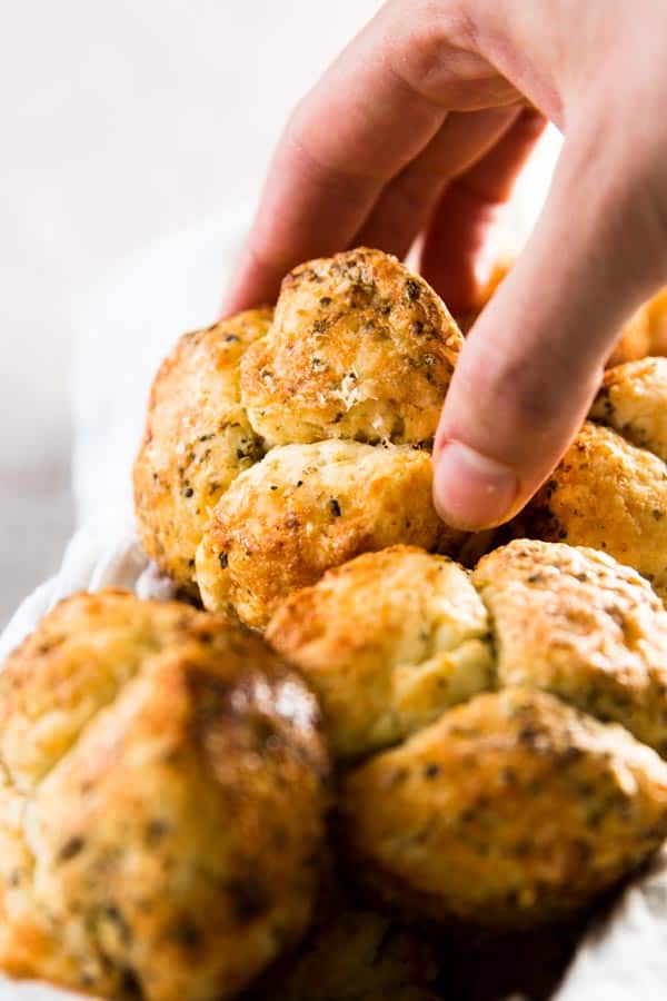 female hand grabbing a savory monkey bread