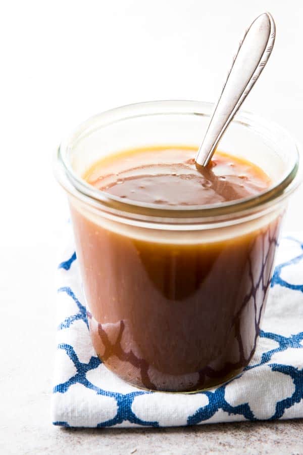 Homemade Teriyaki Sauce in a glass jar with a spoon.