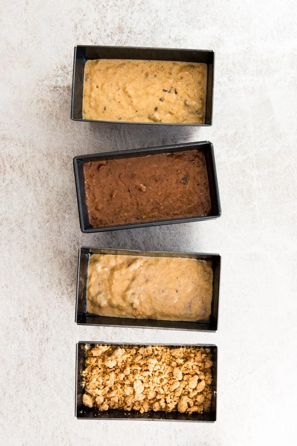 top down view on four loaf pans with banana bread batter