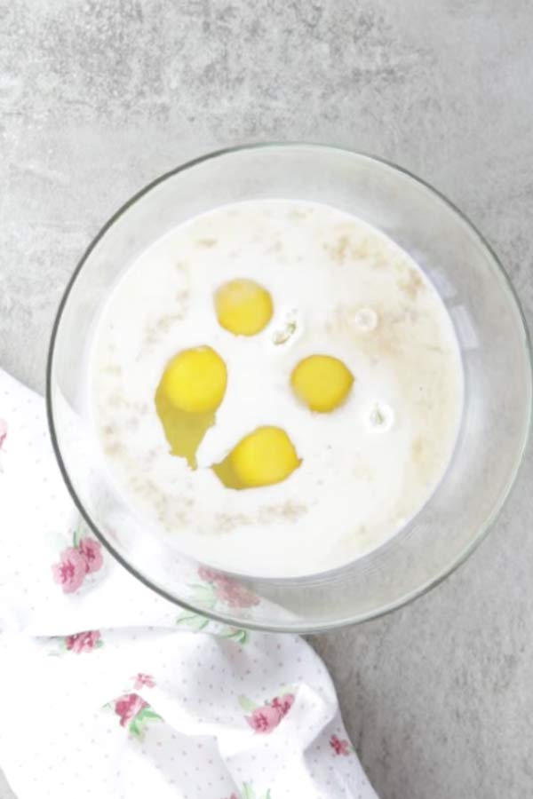 glass bowl filled with ingredients for custard to make french toast