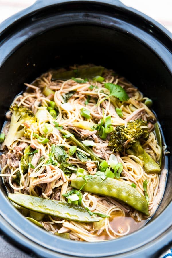 angled view on asian pork and noodles in black crockery
