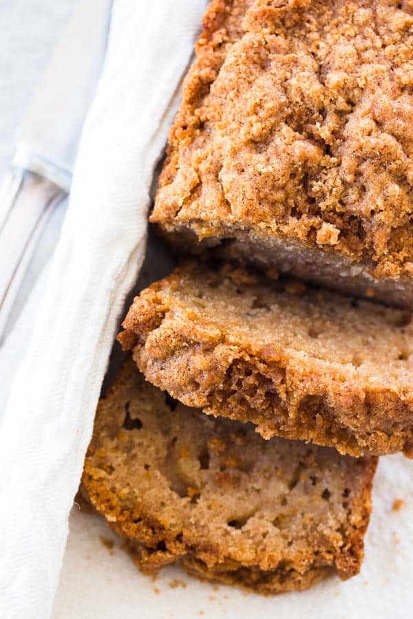 cinnamon crunch banana bread loaf with two slices cut off