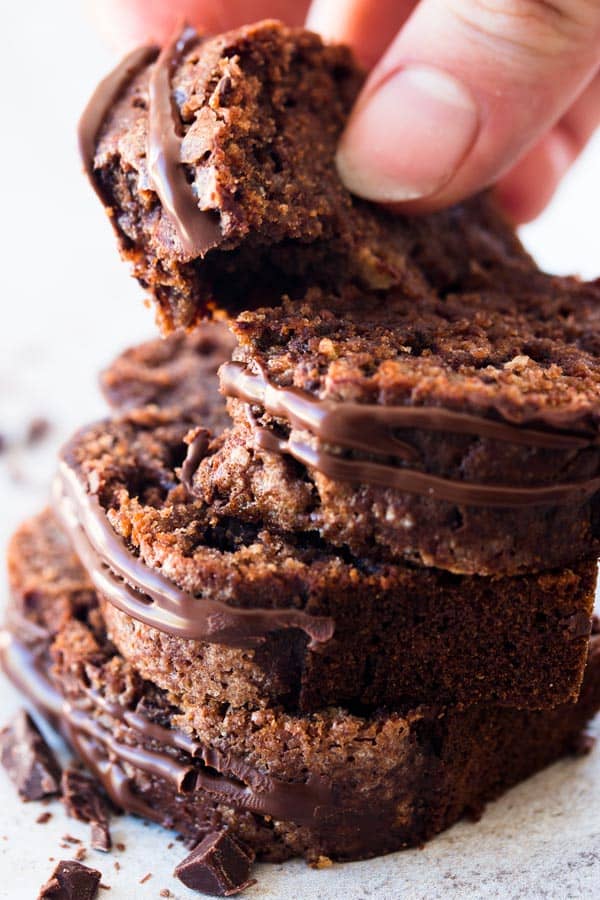 female hand grabbing slice of chocolate banana bread