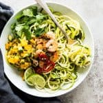 overhead view on white plate with zucchini noodles and shrimp