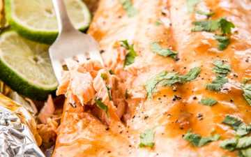 fork stuck into baked salmon