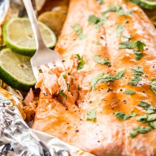 fork stuck into baked salmon