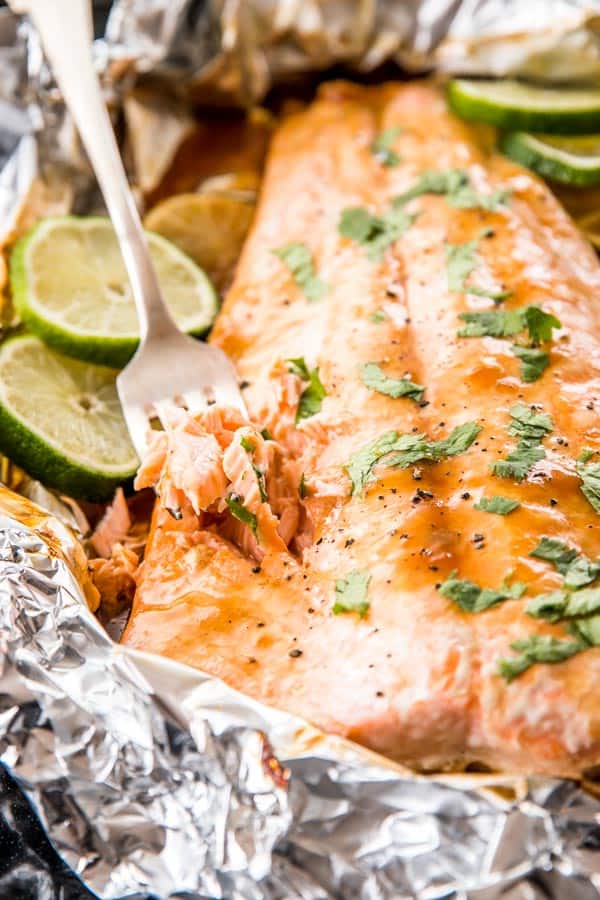 fork stuck into baked salmon