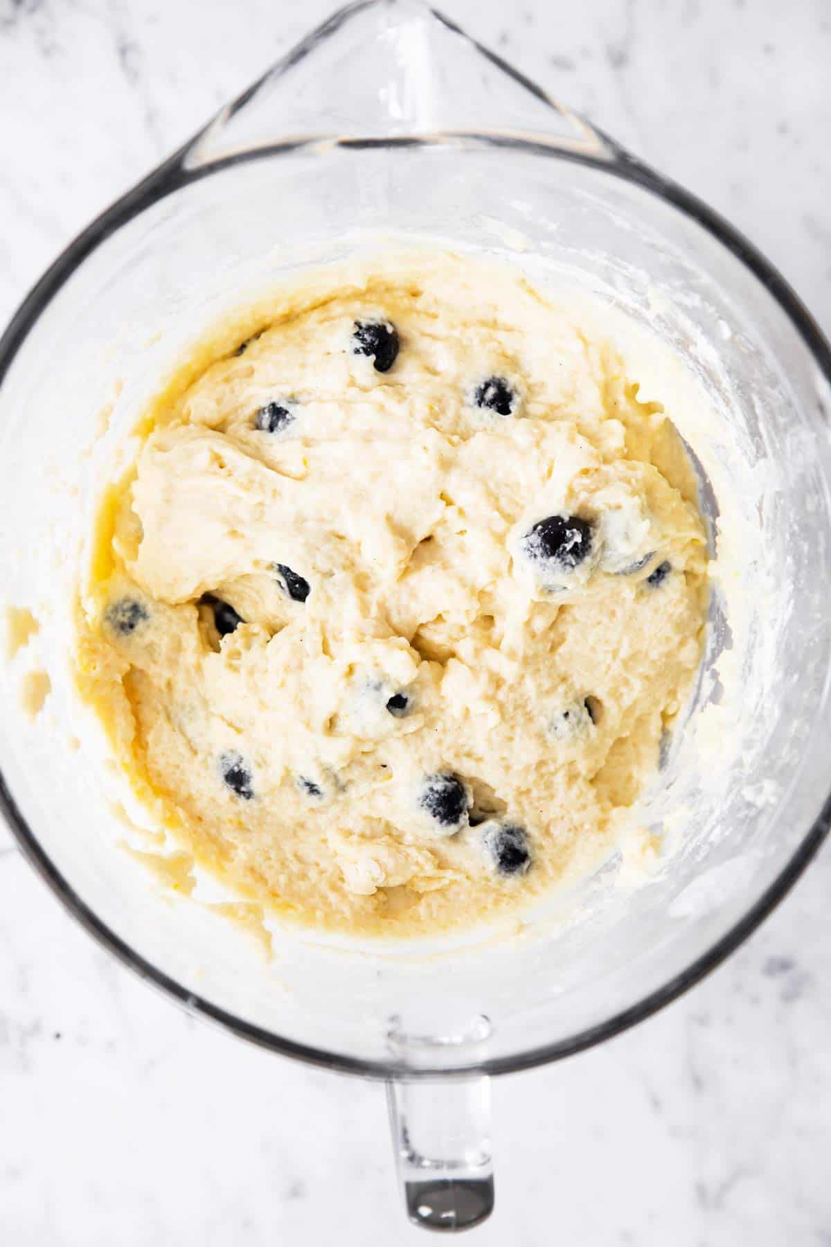 glass bowl with blueberry muffin batter