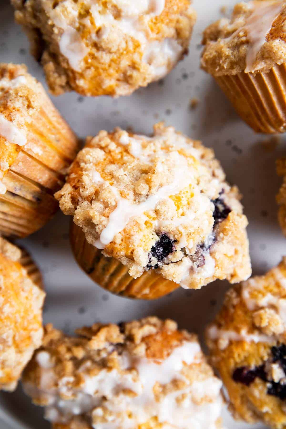 overhead close up of several blueberry muffins on plate