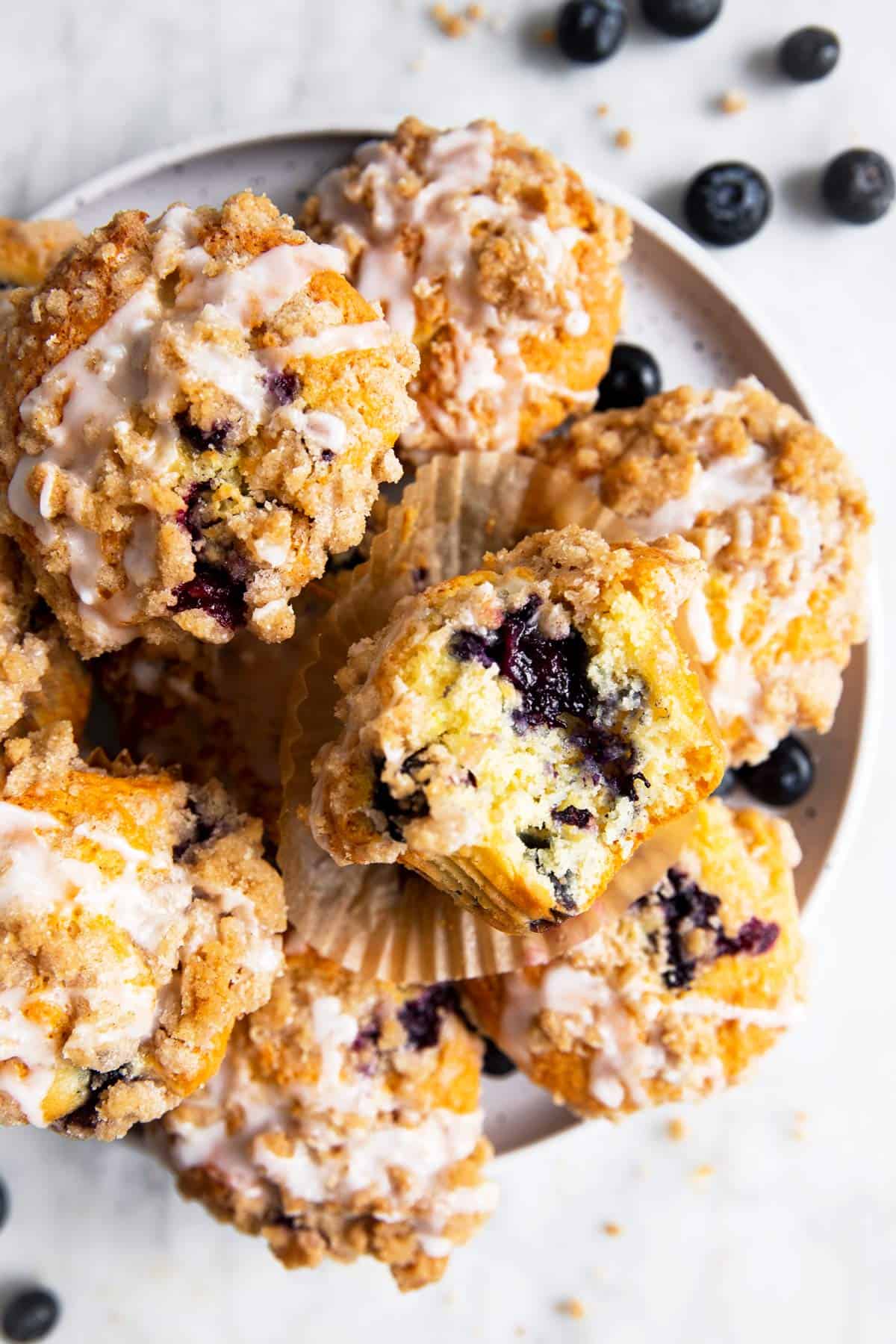 overhead view of blueberry muffins on white plate