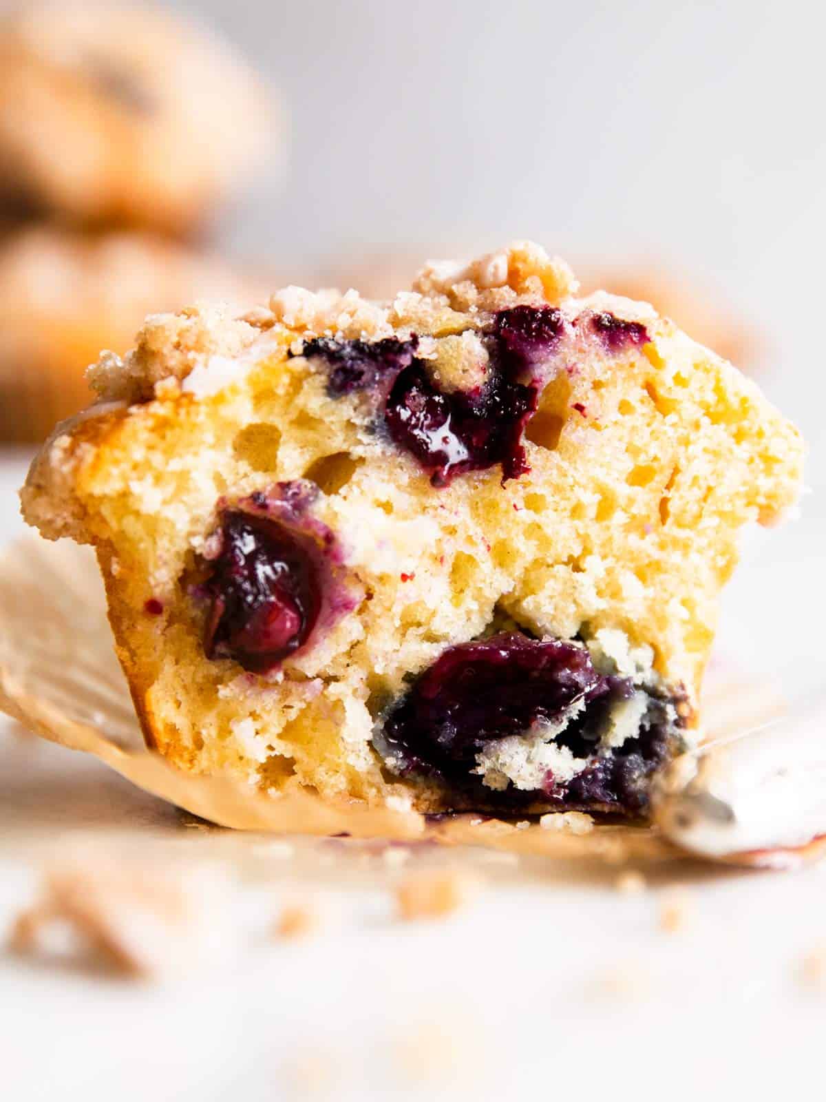 cut in half blueberry muffin on marble counter