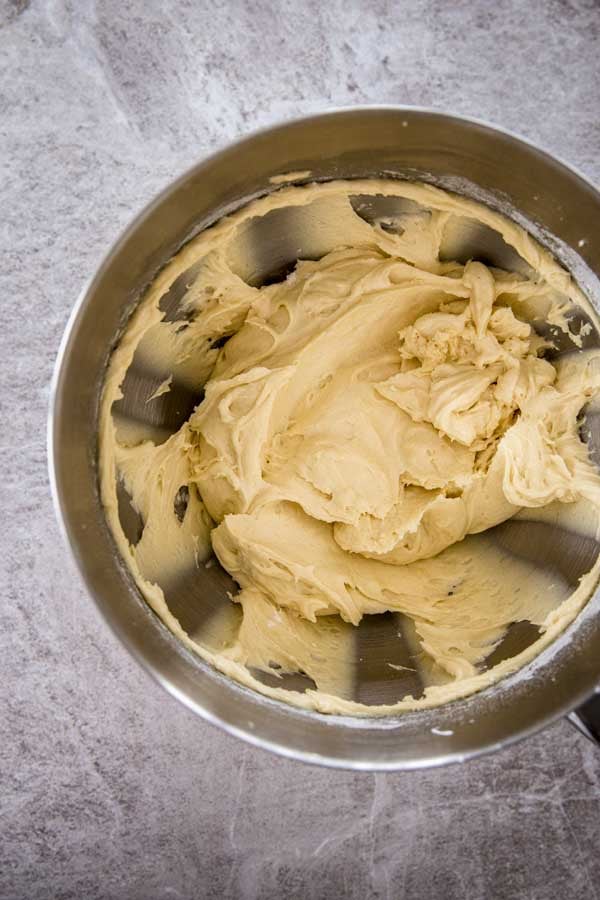 Batter for yogurt raspberry cake in a stand mixer bowl.