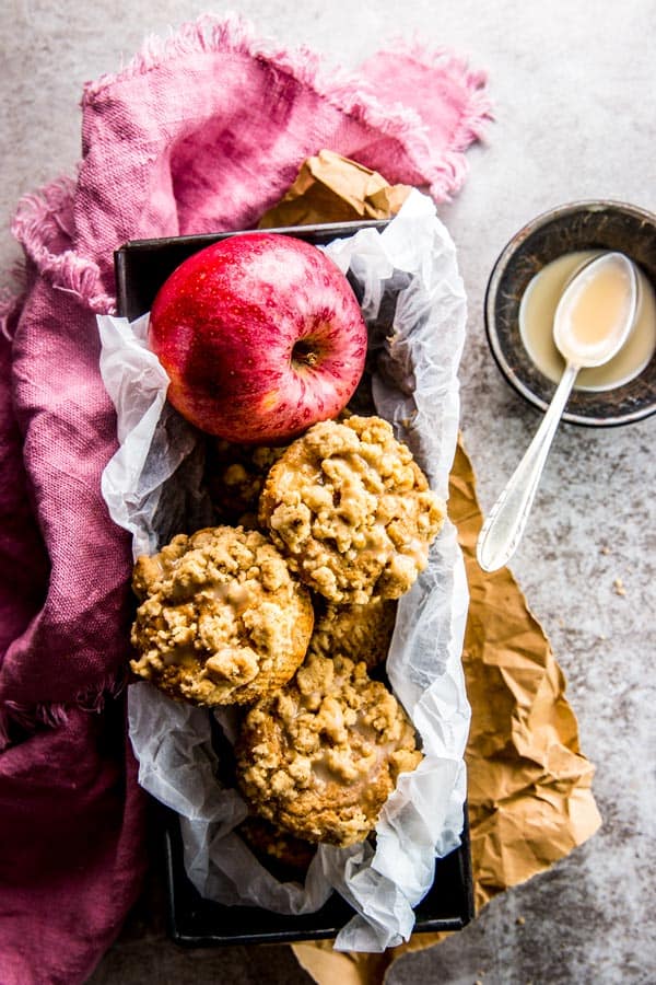 Apple cinnamon muffins nicely packed up into a tin. They'd make a great surprise gift! for a neighbor!