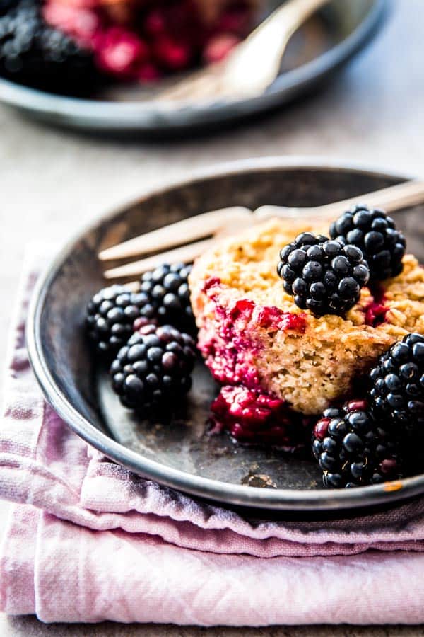 blackberry baked oatmeal cup on dark dish